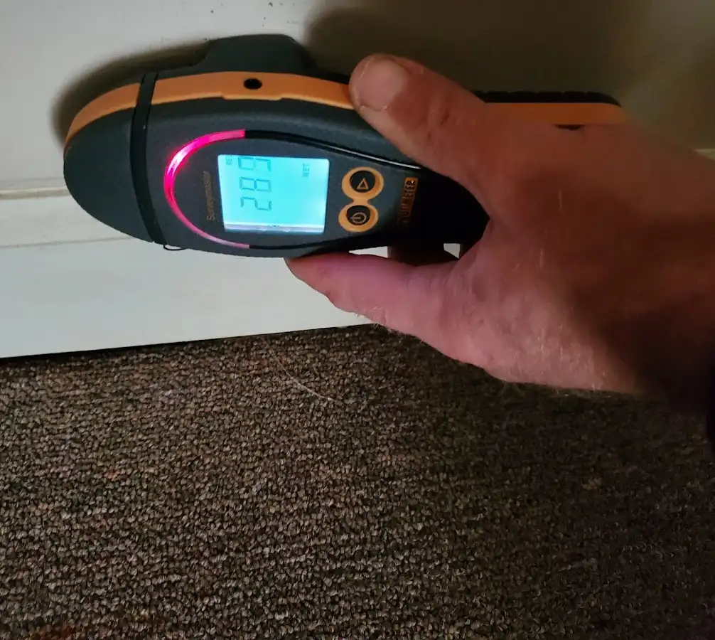 Moisture detection at baseboard during Storm Damage Restoration in Brunswick